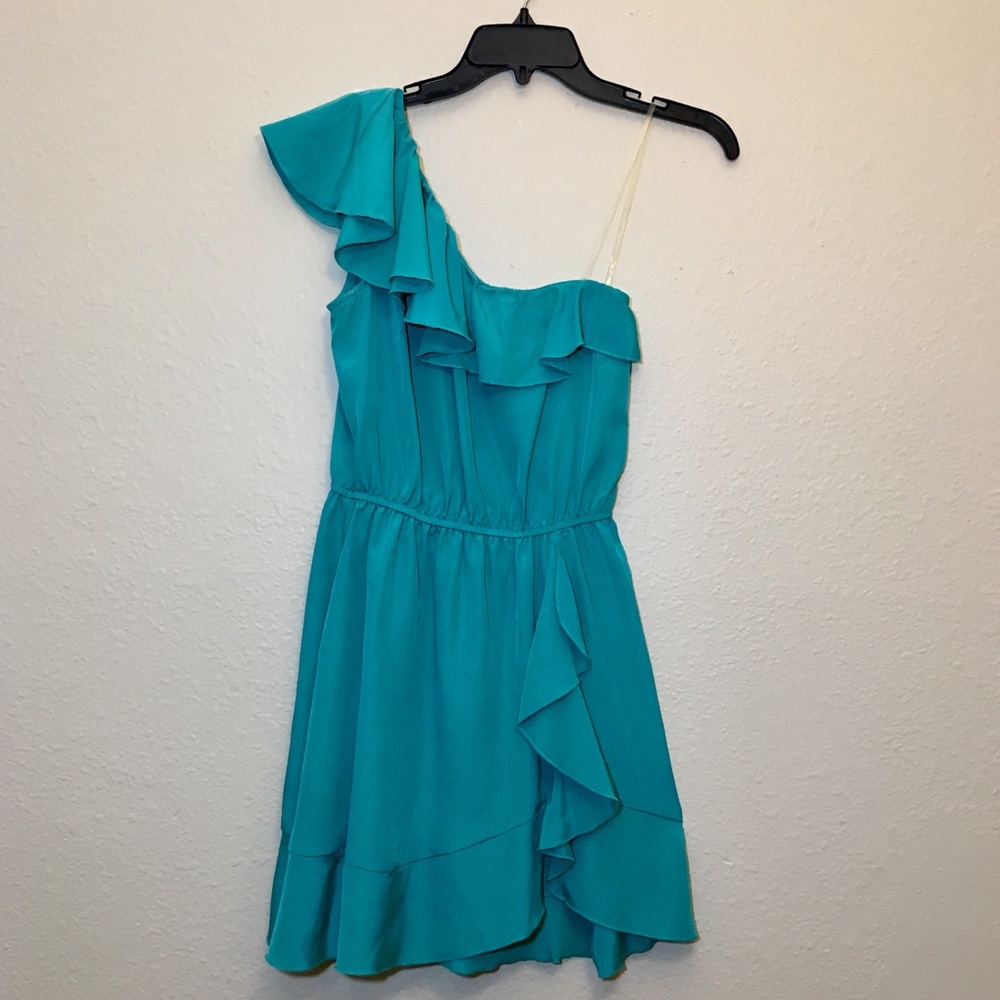 Turquoise one shoulder dress.